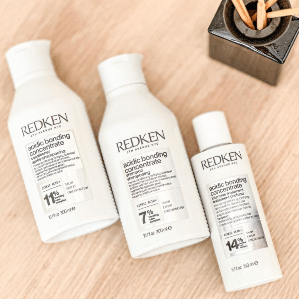 Three bottles of Redken acidic bonding concentrate products