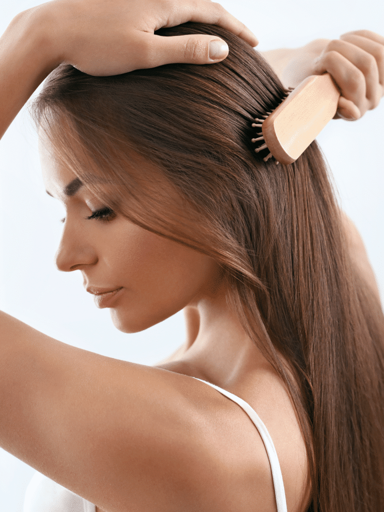 Woman combing her long brown hair